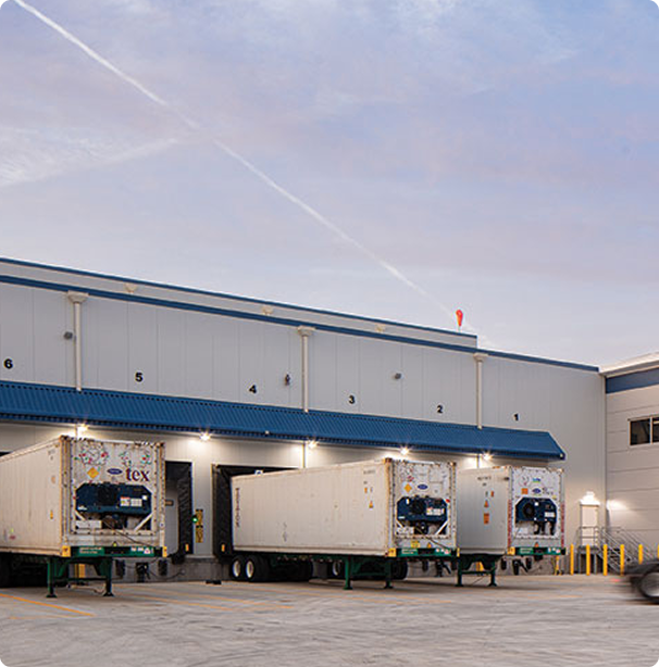Loading dock with two trailers parked outside.